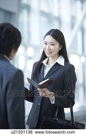 Businesswoman and Businessman Talking in Lobby View Large Photo Image Stock Photo - Businesswoman and Businessman Talking in Lobby. Fotosearch