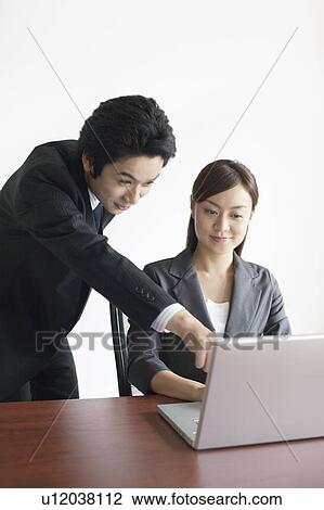 Businesswoman and Businessman Working at Laptop View Large Photo Image Stock Image - Businesswoman and Businessman Working at Laptop. Fotosearch