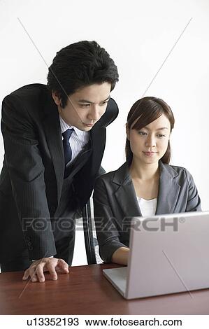 Businesswoman and Businessman Working at Laptop View Large Photo Image Stock Image - Businesswoman and Businessman Working at Laptop. Fotosearch