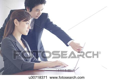 Businesswoman and Businessman Working at Laptop View Large Photo Image Stock Image - Businesswoman and Businessman Working at Laptop. Fotosearch