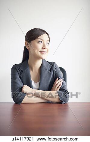 Stock Image - Businesswoman at Desk. Fotosearch
