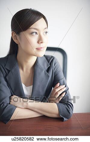 Stock Image - Businesswoman at Desk. Fotosearch