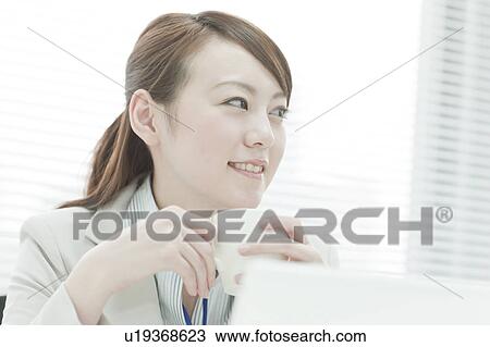 Stock Image - Businesswoman Having Coffee. Fotosearch