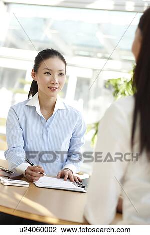 Stock Image - Businesswoman Interviewing Another Woman. Fotosearch