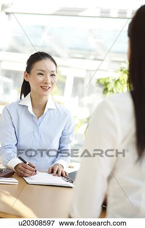 Stock Photo - Businesswoman Interviewing Another Woman. Fotosearch