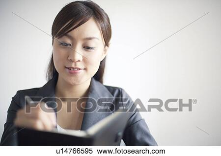 Stock Photography - Businesswoman Planning with Personal Organizer. Fotosearch