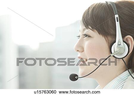 Stock Image - Businesswoman Using Headset. Fotosearch