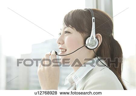 Stock Photo - Businesswoman Using Headset. Fotosearch