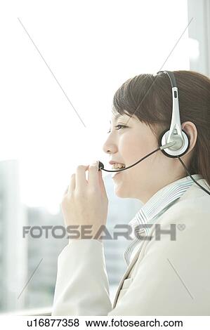 Stock Photo - Businesswoman Using Headset. Fotosearch
