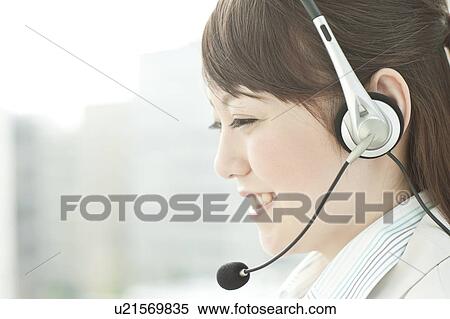 Stock Photography - Businesswoman Using Headset. Fotosearch