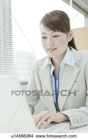 Picture - Businesswoman Using Laptop. Fotosearch