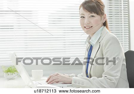 Stock Image - Businesswoman Using Laptop. Fotosearch