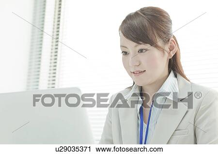 Stock Image - Businesswoman Using Laptop. Fotosearch
