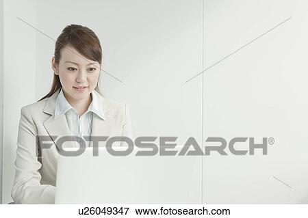 Stock Photo - Businesswoman Using Laptop. Fotosearch