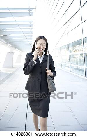 Businesswoman Walking and Talking On Phone View Large Photo Image Stock Image - Businesswoman Walking and Talking On Phone. Fotosearch