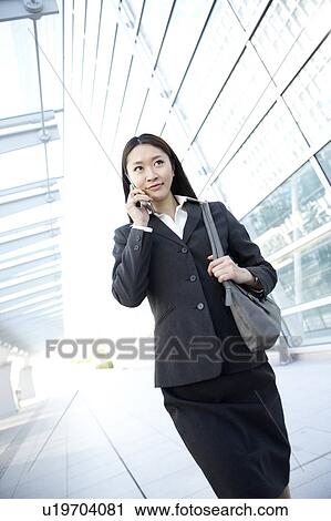 Businesswoman Walking and Talking On Phone View Large Photo Image Stock Image - Businesswoman Walking and Talking On Phone. Fotosearch
