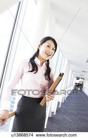 Picture - Businesswoman Walking in Corridor. Fotosearch