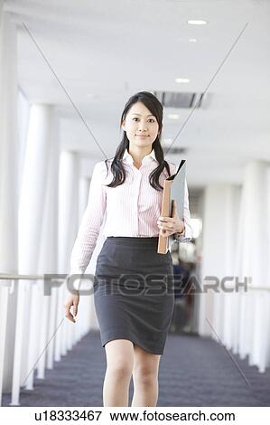 Stock Photo - Businesswoman Walking in Corridor. Fotosearch
