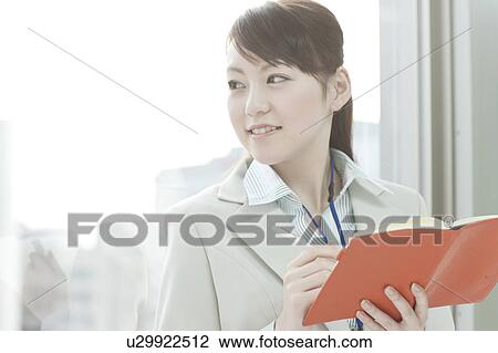 Stock Image - Businesswoman with Notebook. Fotosearch