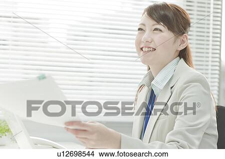 Picture - Businsswoman Holding Documents. Fotosearch