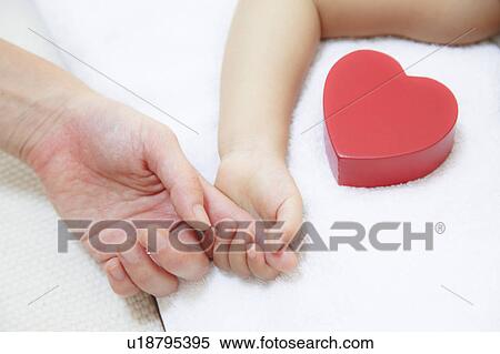 Daughter holding Mother's finger View Large Photo Image Stock Photography - Daughter holding Mother's finger. Fotosearch