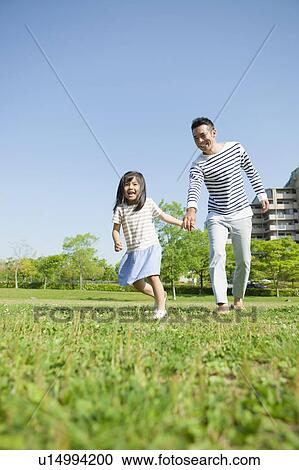 Stock Image - Daughter Pulling Father's Hand. Fotosearch