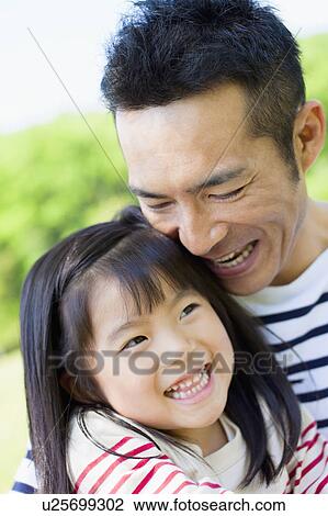 Daughter sitting on father's lap View Large Photo Image Stock Image - Daughter sitting on father's lap. Fotosearch