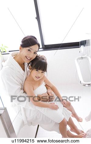 Daughter sitting on mother's lap View Large Photo Image Stock Photography - Daughter sitting on mother's lap. Fotosearch