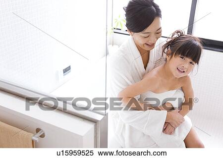 Daughter sitting on mother's lap View Large Photo Image Stock Photography - Daughter sitting on mother's lap. Fotosearch