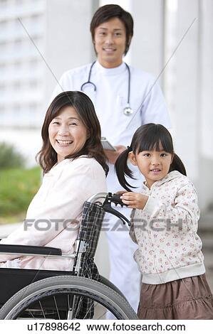 Stock Image - Doctor with Grandmother and Granddaughter. Fotosearch