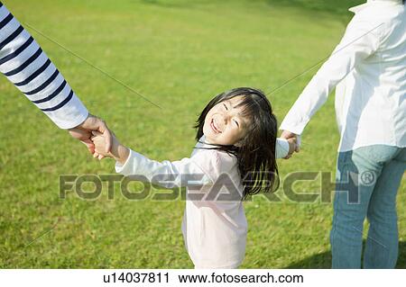 Stock Image - Family holding hands. Fotosearch