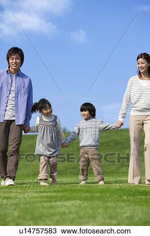 Stock Image - Family of Four in Field. Fotosearch