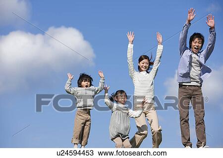Stock Image - Family of Four Jumping of Joy. Fotosearch