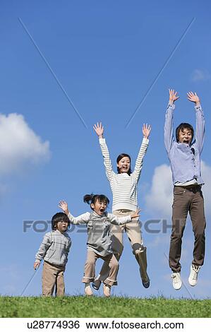 Stock Photograph - Family of Four Jumping. Fotosearch