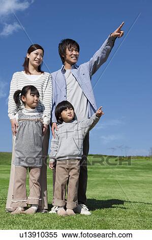 Family of Four Pointing in Park View Large Photo Image Stock Photography - Family of Four Pointing in Park. Fotosearch