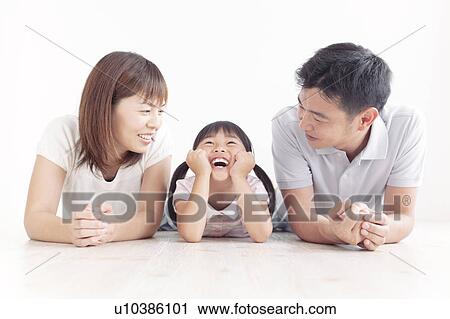 Stock Image - Family of Three Lying on Floor. Fotosearch