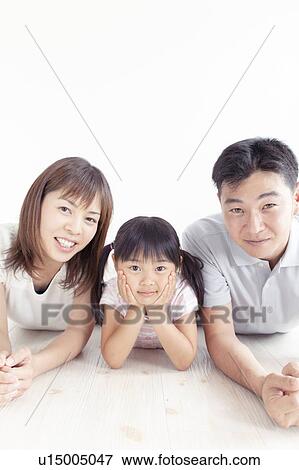 Stock Photo - Family of Three Lying on Floor. Fotosearch