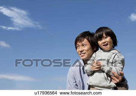 Picture - Father and Boy Against Blue Sky. Fotosearch