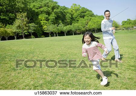 Stock Photo - Father and daughter at a park. Fotosearch