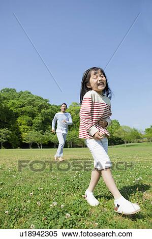 Stock Photography - Father and daughter at a park. Fotosearch