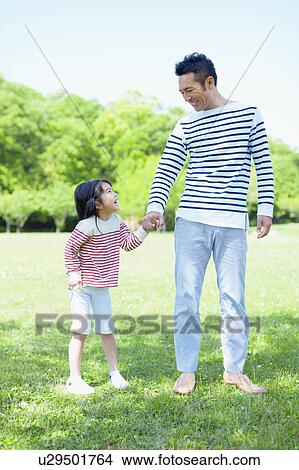 Picture - Father and daughter holding hands. Fotosearch