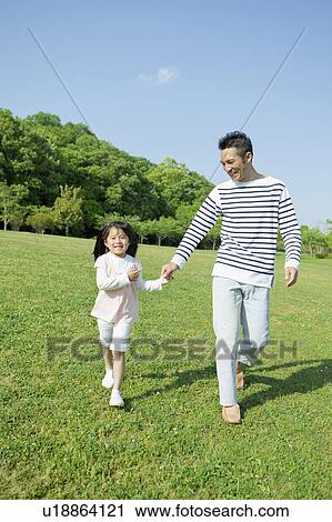 Stock Image - Father and daughter holding hands. Fotosearch