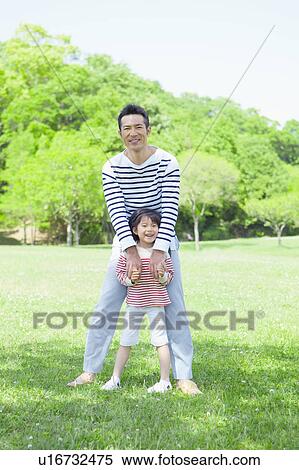 Stock Photography - Father and daughter holding hands. Fotosearch
