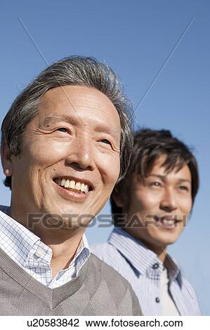 Stock Image - Father and Son Against Blue Sky. Fotosearch