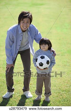 Stock Photo - Father and Son with Soccer Ball. Fotosearch