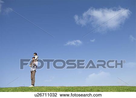 Father Carrying Boy on Shoulders in Field View Large Photo Image Stock Image - Father Carrying Boy on Shoulders in Field. Fotosearch
