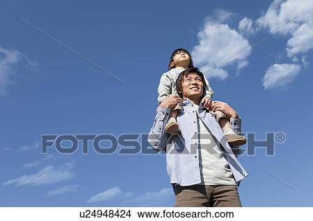 Picture - Father Carrying Boy on Shoulders. Fotosearch