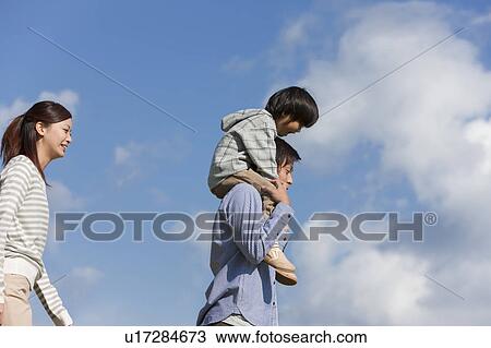 Father Carrying Son on Shoulders, Mother Beside View Large Photo Image Stock Image - Father Carrying Son on Shoulders, Mother Beside. Fotosearch