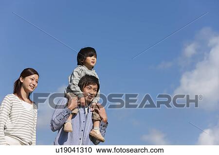Father Carrying Son on Shoulders, Mother Beside View Large Photo Image Stock Image - Father Carrying Son on Shoulders, Mother Beside. Fotosearch