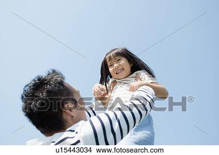 Father picking up daughter View Large Photo Image Picture - Father picking up daughter. Fotosearch